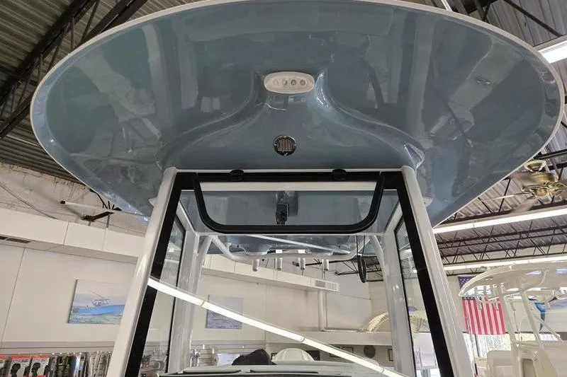 Slide: The Image of 2025 Sea Hunt Ultra 255 SE boat T-top in showroom, showcasing sleek design. - 6