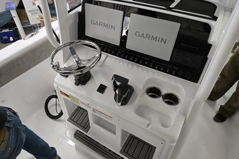 Slide: The Image of 2025 Sea Hunt Ultra 255 SE boat dashboard with Garmin displays and steering wheel. - 8