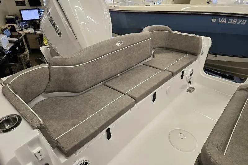 Slide: The Image of 2025 Sea Hunt Ultra 255 SE boat interior with cushioned seating and modern design. - 9