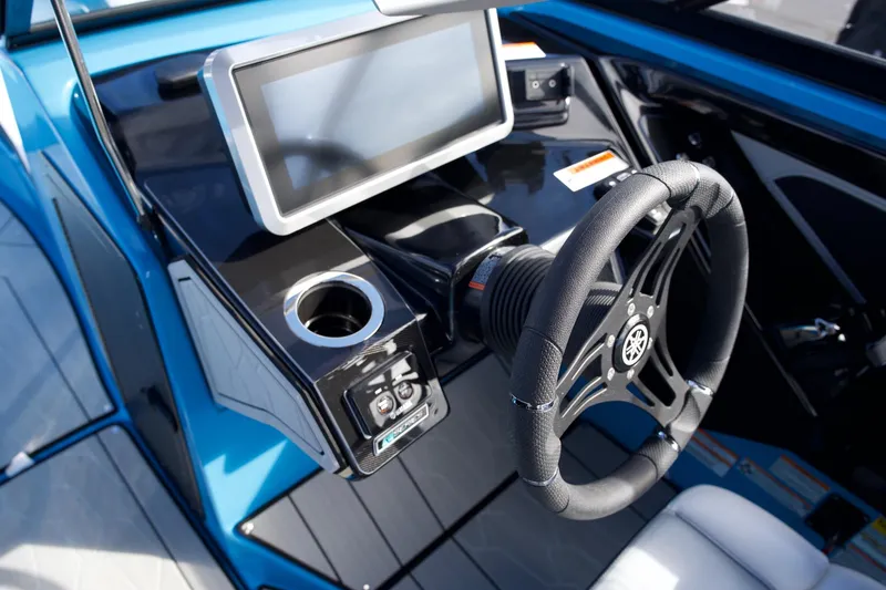 Slide: The Image of 2023 Yamaha Boats 255XD dashboard with steering wheel and touchscreen display. - 10