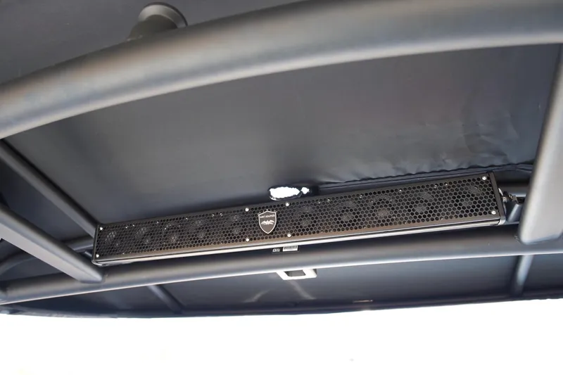 Slide: The Image of 2023 Yamaha Boats 255XD sound system detail under canopy. - 23