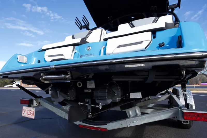 Slide: The Image of 2023 Yamaha Boats 255XD on trailer, showcasing rear view and sleek design. - 26