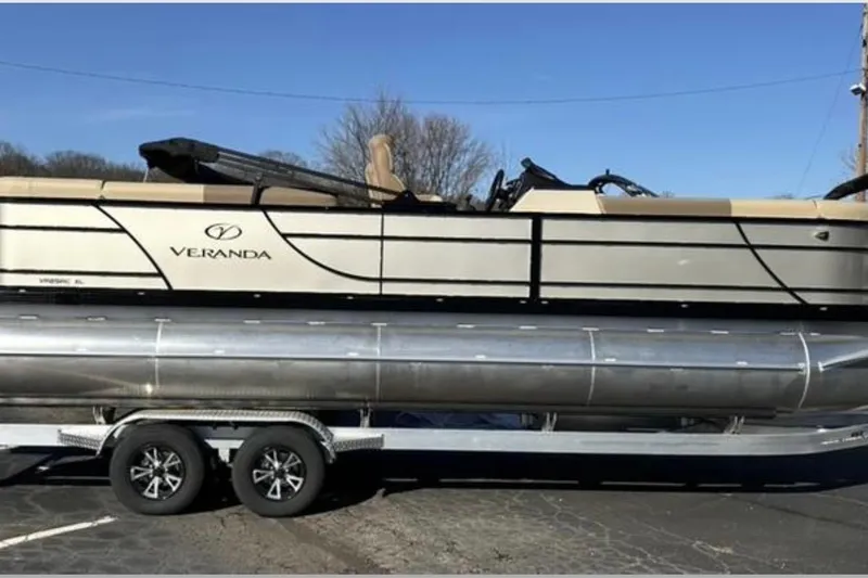 Slide: The Image of 2025 Veranda VR25RC XL pontoon boat on trailer, side view, sunny day. - 3