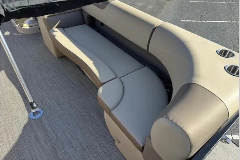 Slide: The Image of Luxurious seating on 2025 Veranda VR25RC XL pontoon boat, featuring beige upholstery and cup holders. - 5