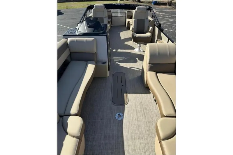 Slide: The Image of 2025 Veranda VR25RC XL pontoon boat interior with beige seating and spacious layout. - 6
