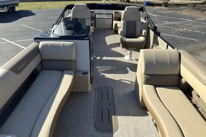 Slide: The Image of 2025 Veranda VR25RC XL pontoon boat interior with beige seating and spacious layout. - 7
