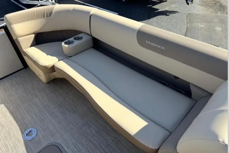 Slide: The Image of 2025 Veranda VR25RC XL boat seating with cup holders, beige upholstery, and spacious design. - 8