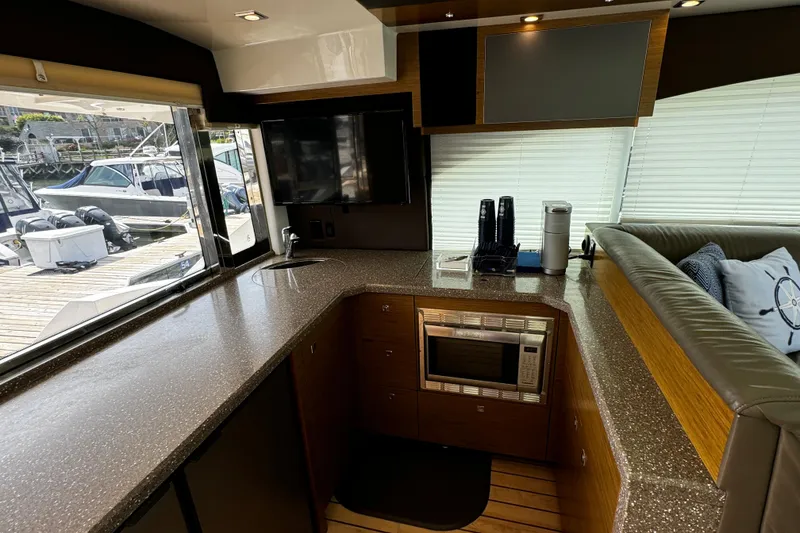 Slide: The Image of Interior of 2014 Cruisers Yachts 45 Cantius with modern kitchen and dockside view. - 10
