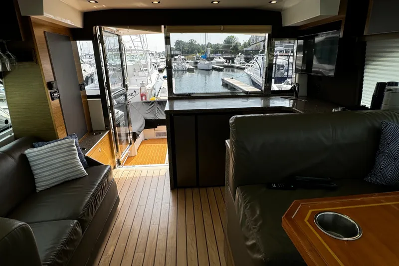 Slide: The Image of Interior of 2014 Cruisers Yachts 45 Cantius with marina view through open doors. - 12