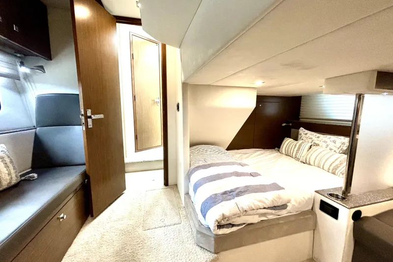 Slide: The Image of Interior of 2014 Cruisers Yachts 45 Cantius, featuring cozy bedroom and seating area. - 15