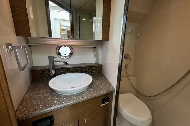Slide: The Image of Luxurious bathroom in 2014 Cruisers Yachts 45 Cantius with modern fixtures and porthole window. - 19