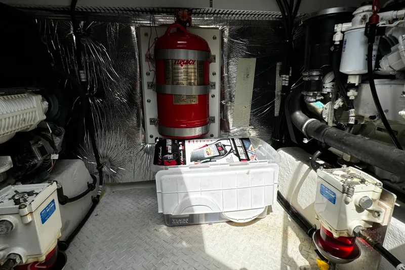 Slide: The Image of Engine room of 2014 Cruisers Yachts 45 Cantius with fire extinguisher and equipment. - 25