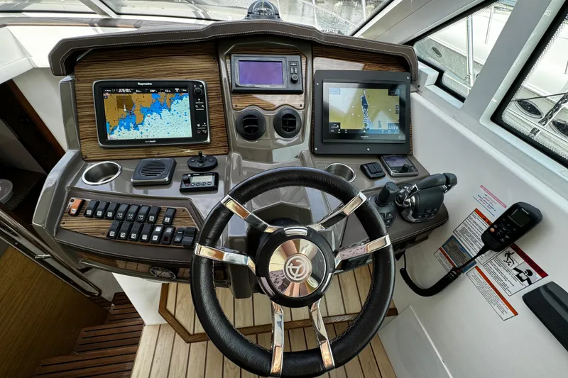 Slide: The Image of Helm of 2014 Cruisers Yachts 45 Cantius with navigation screens and controls. - 14