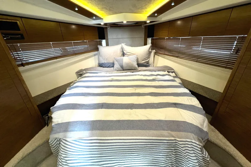 Slide: The Image of Luxurious bedroom interior of 2014 Cruisers Yachts 45 Cantius with striped bedding. - 21
