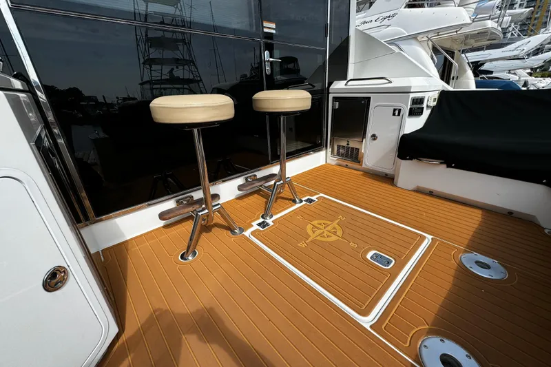 Slide: The Image of 2014 Cruisers Yachts 45 Cantius deck with bar stools and teak flooring. - 6
