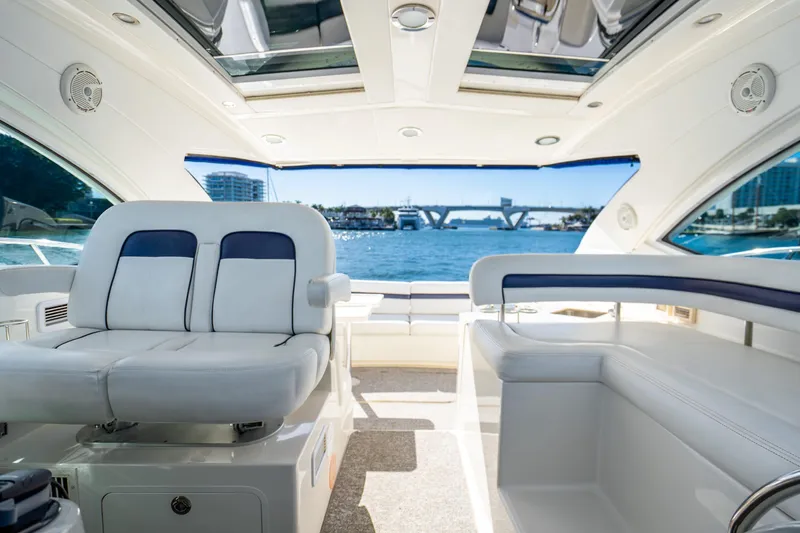 Slide: The Image of Interior view of 2009 Sea Ray 470 Sundancer yacht with luxurious seating and ocean backdrop. - 14