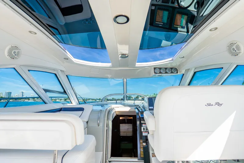 Slide: The Image of Interior view of 2009 Sea Ray 470 Sundancer yacht with panoramic windows and luxurious seating. - 16