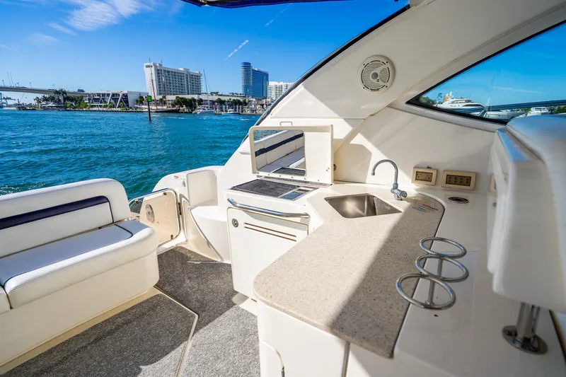 Slide: The Image of Luxurious 2009 Sea Ray 470 Sundancer yacht interior with kitchenette and waterfront view. - 20