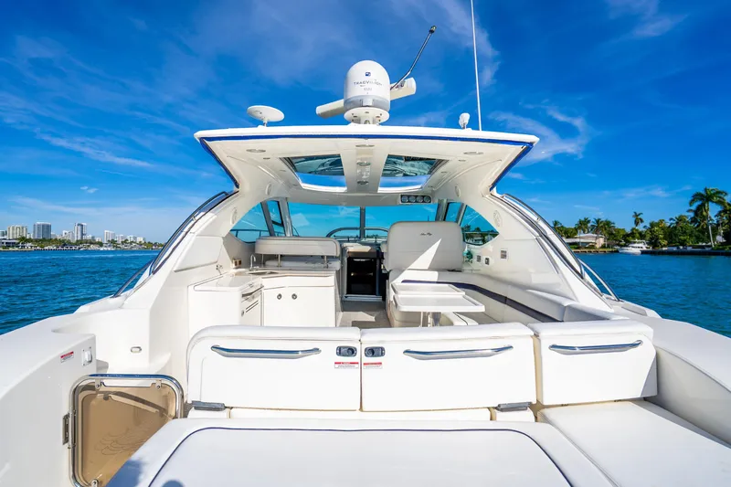Slide: The Image of 2009 Sea Ray 470 Sundancer yacht with spacious deck and luxurious seating on a sunny day. - 21