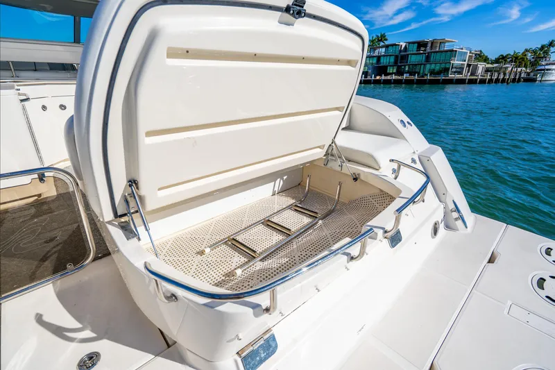Slide: The Image of 2009 Sea Ray 470 Sundancer swim platform with open storage compartment and ladder. - 24