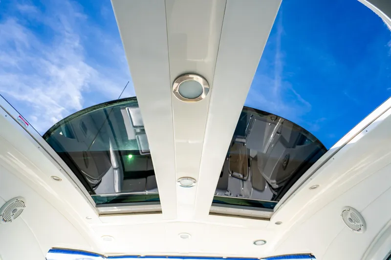 Slide: The Image of 2009 Sea Ray 470 Sundancer yacht with open sunroof against blue sky. - 25
