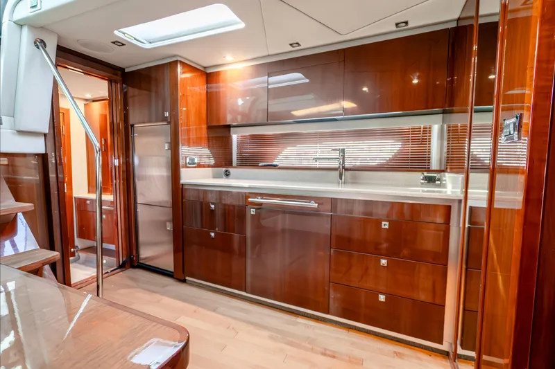 Slide: The Image of Luxurious 2009 Sea Ray 470 Sundancer yacht interior with sleek wooden cabinetry and modern design. - 27