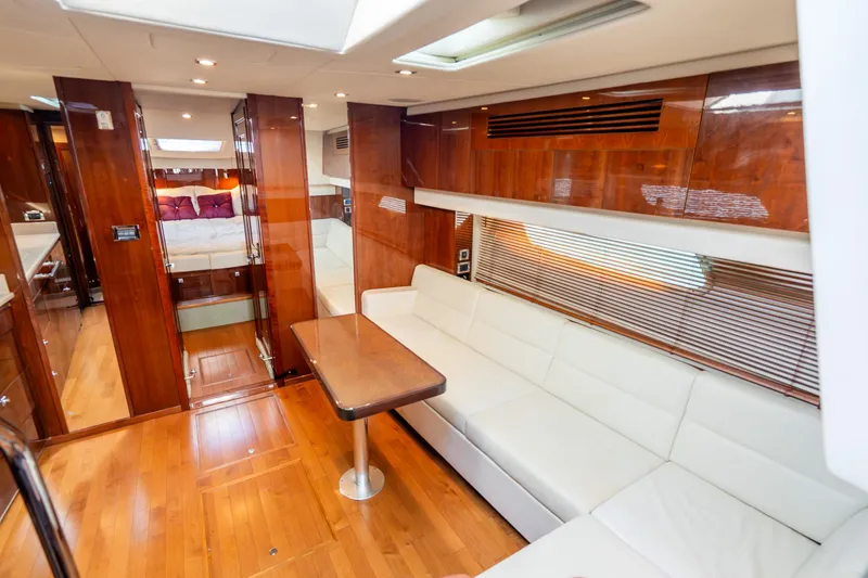 Slide: The Image of Luxurious interior of 2009 Sea Ray 470 Sundancer yacht with wood finishes and white seating. - 28