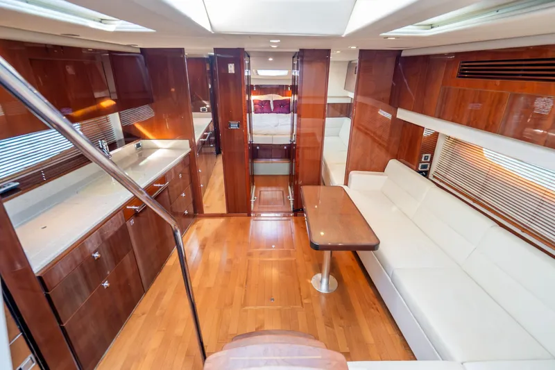 Slide: The Image of Luxurious interior of 2009 Sea Ray 470 Sundancer yacht with wood finishes and white seating. - 29