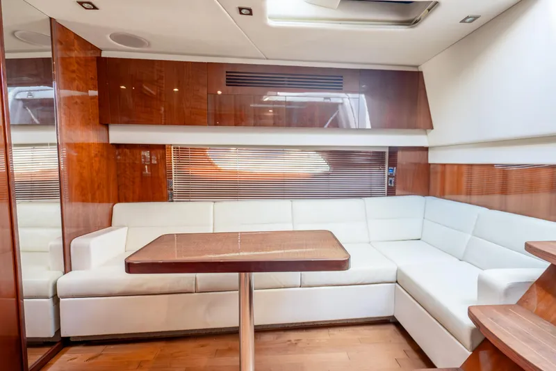 Slide: The Image of Luxurious interior of 2009 Sea Ray 470 Sundancer yacht with white seating and wooden accents. - 32