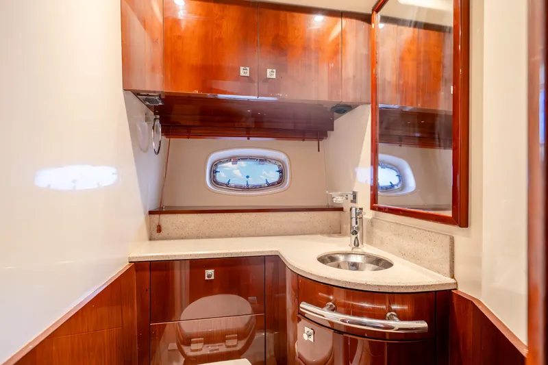 Slide: The Image of Luxurious 2009 Sea Ray 470 Sundancer yacht bathroom with wood cabinetry and modern fixtures. - 37