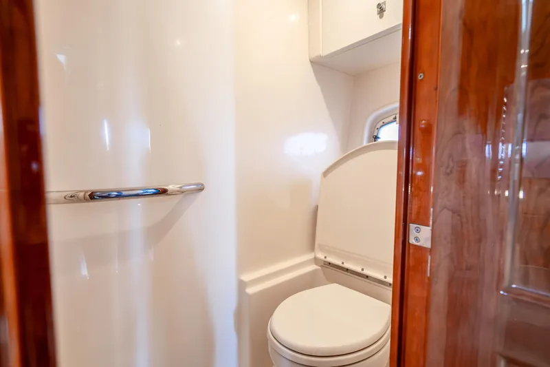 Slide: The Image of 2009 Sea Ray 470 Sundancer yacht bathroom with modern fixtures and wooden accents. - 40