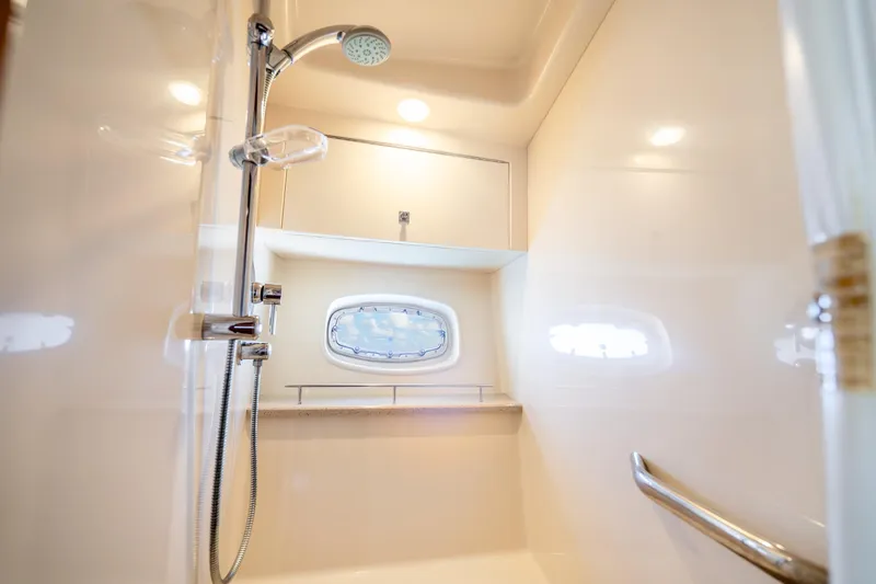 Slide: The Image of Luxurious shower in 2009 Sea Ray 470 Sundancer yacht, featuring modern fixtures and porthole window. - 42