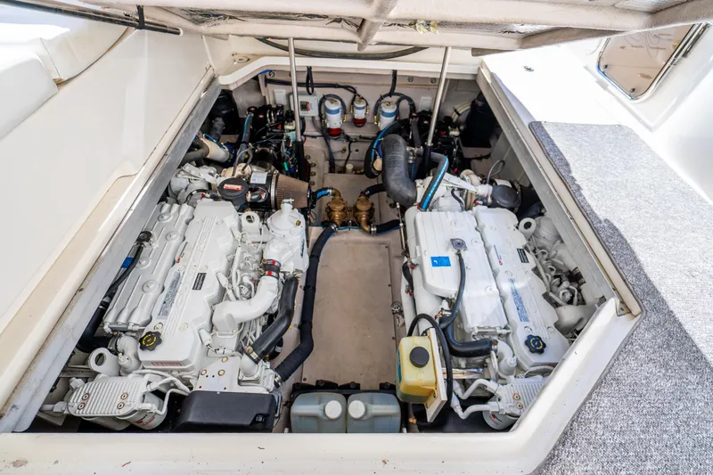 Slide: The Image of Engine room of a 2009 Sea Ray 470 Sundancer, showcasing dual engines and mechanical components. - 43