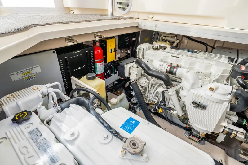 Slide: The Image of Engine room of 2009 Sea Ray 470 Sundancer yacht, showcasing mechanical components and fire extinguisher. - 45