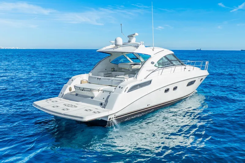 Slide: The Image of 2009 Sea Ray 470 Sundancer yacht cruising on clear blue ocean waters. - 6