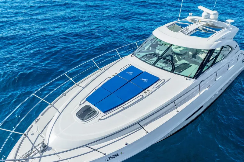 Slide: The Image of 2009 Sea Ray 470 Sundancer yacht cruising on clear blue ocean waters. - 8