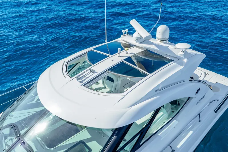 Slide: The Image of 2009 Sea Ray 470 Sundancer yacht on clear blue ocean waters. - 9