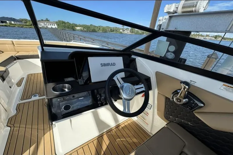 Slide: The Image of 2024 Sea Ray SDX 270 dashboard with steering wheel and control panel. - 14