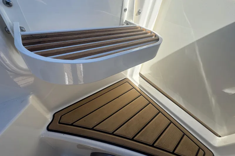 Slide: The Image of 2024 Sea Ray SDX 270 boat with teak steps and white trim. - 26