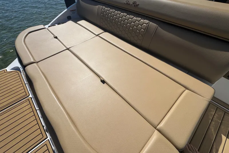 Slide: The Image of 2024 Sea Ray SDX 270 boat with tan cushioned seating and stylish design. - 29