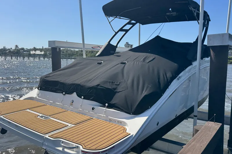Slide: The Image of 2024 Sea Ray SDX 270 boat with teak swim platform on water. - 3