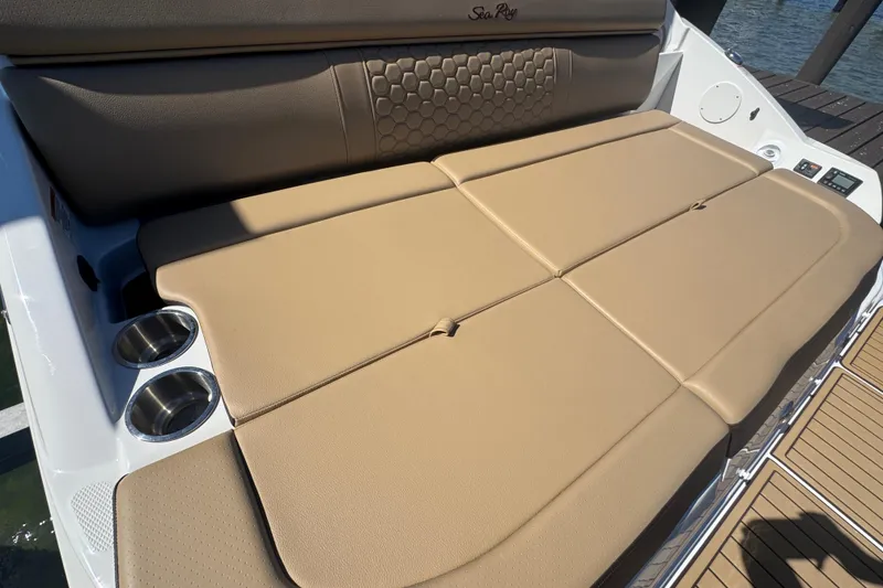 Slide: The Image of 2024 Sea Ray SDX 270 boat with tan cushioned seating and cup holders. - 31