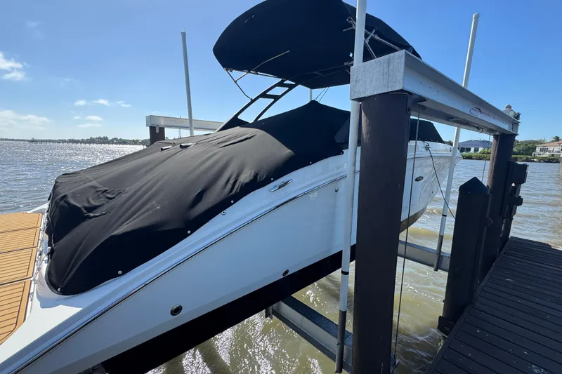 Slide: The Image of 2024 Sea Ray SDX 270 boat on lift, displaying registration FL 3016 TR. - 4