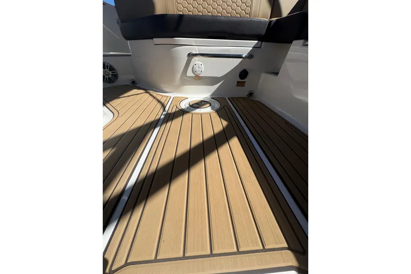 Slide: The Image of 2024 Sea Ray SDX 270 boat interior with teak flooring and cushioned seating. - 45