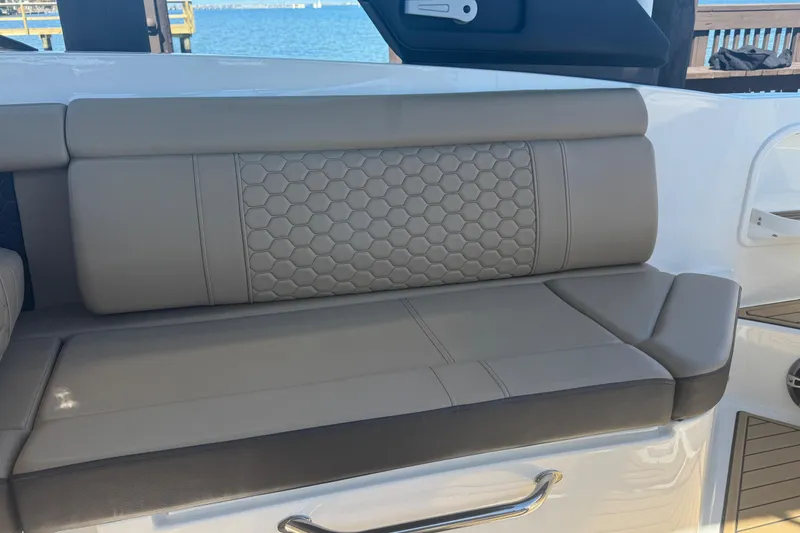 Slide: The Image of 2024 Sea Ray SDX 270 boat seating with hexagonal pattern upholstery, dockside view. - 46