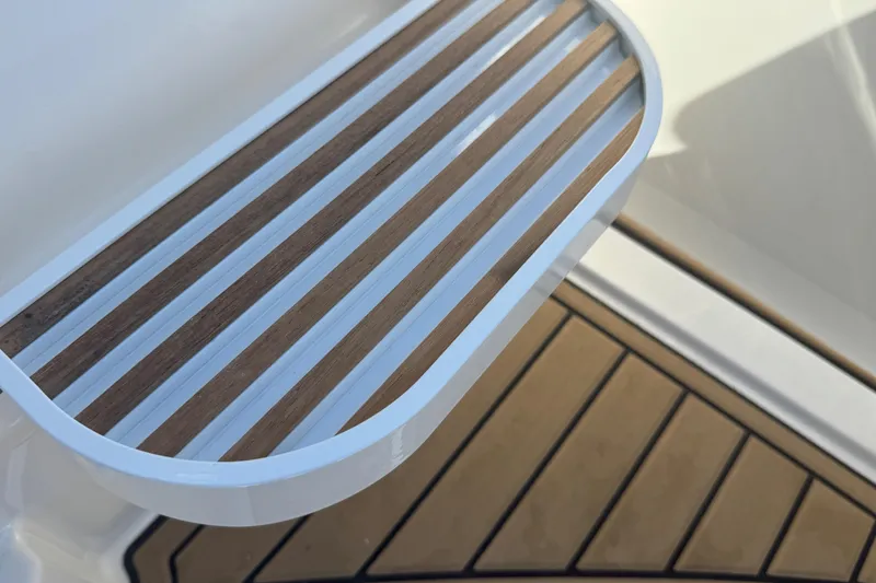 Slide: The Image of 2024 Sea Ray SDX 270 boat deck with wood and white accents. - 47