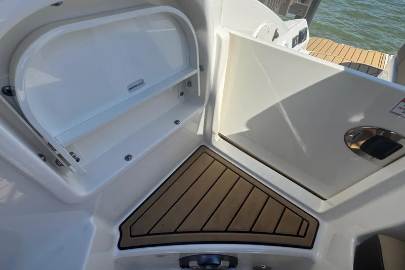Slide: The Image of 2024 Sea Ray SDX 270 boat interior with storage compartment and teak flooring. - 48