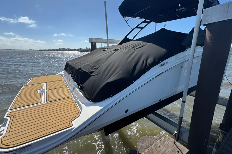Slide: The Image of 2024 Sea Ray SDX 270 boat hull on lift above water. - 5