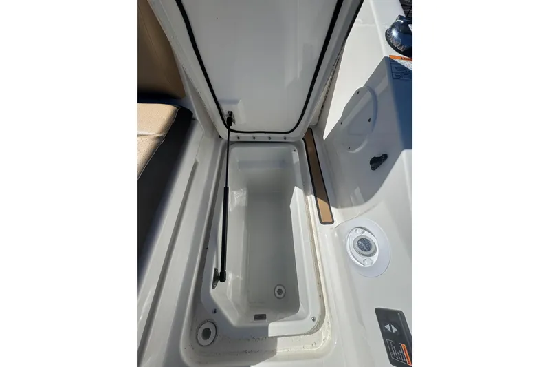 Slide: The Image of Open storage compartment on 2024 Sea Ray SDX 270 boat, showcasing interior space. - 51