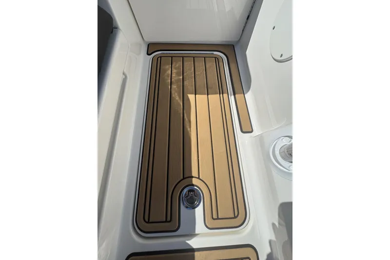 Slide: The Image of 2024 Sea Ray SDX 270 boat deck with sleek wood finish and modern design. - 52
